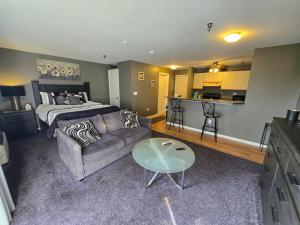 a living room with a couch and a bed at Paugus Bay Condo Close to it All in Laconia
