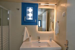 bagno con lavandino e cabina blu di Dreamview Tinos a Kardhianí Altre 24 foto