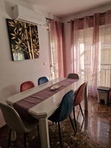 a dining room with a table and some chairs at Alfer in Cazorla +2 photos
