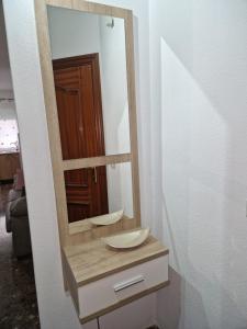 a bathroom with a mirror and a sink at Alfer in Cazorla