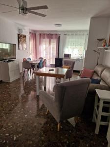 a living room with a couch and a table and chairs at Alfer in Cazorla