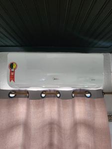a white suitcase sitting on top of a bed at Kitnet mobiliada em Lins in Lins
