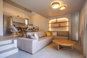 a living room with a couch and a table at Anemelia Villas in Karpathos Town