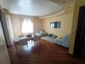 a living room with a couch and a table and chairs at Casa Terzi in Bologna