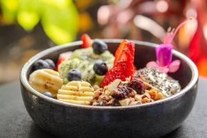 a bowl filled with fruit and other foods at Haven A Design Hotel in Medellín +12 photos