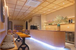 a bar in a restaurant with a table and chairs at Vaia Hoi An Boutique Hotel in Hoi An