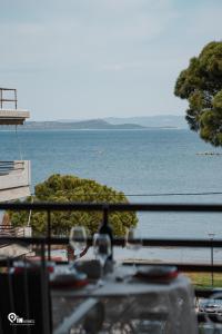 a view of the ocean from a balcony at Nefeli - Unique Beachfront Apartment in Nea Makri
