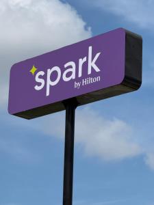 a purple street sign with the words spark by hilton at Spark by Hilton Opelousas in Opelousas
