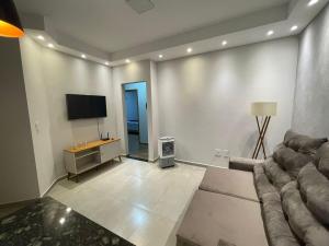 a living room with a couch and a flat screen tv at Casa Oliva in Franca