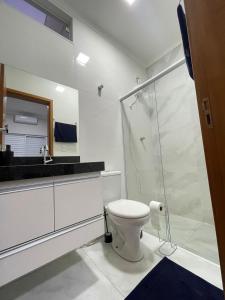 a bathroom with a toilet and a glass shower at Casa Oliva in Franca +4 photos