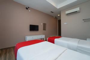 Postel nebo postele na pokoji v ubytování New Bangi Gateway Hotel