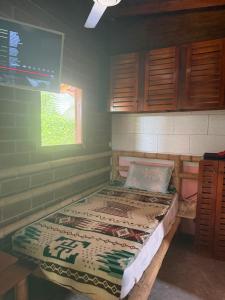 a large bed in a room with green walls at Casa playa Manglaralto in Manglaralto