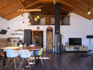 a kitchen and dining room with a table and chairs at Chata Trajlínky in Oravská Lesná