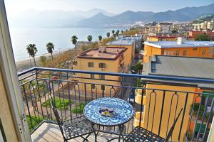 a balcony with a table and a view of the ocean at Terrazza Marconi in Salerno