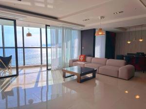 a living room with a couch and a table at Haeundae Luxury House in Busan