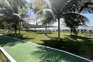 a swimming pool with palm trees in a park at Jubiabá - 214C - Vista Mar in Ilhéus