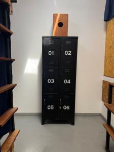 a black cabinet with a paper towel on top of it at SG Paracas Hostel in Paracas +18 photos