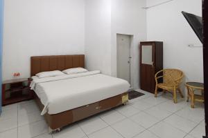 Voodi või voodid majutusasutuse OYO 92207 Hotel Koperasi toas