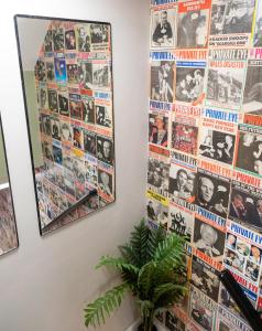 a wall with posters offamousvariations on the wall at Starbeck Serviced Apartments in Harrogate