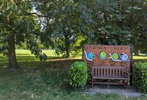 a park bench with a sign that reads shakespeare in browser at Starbeck Serviced Apartments in Harrogate
