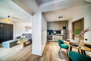a kitchen and living room with a table and chairs at Windmill Escape Apartments B in Chios