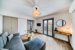 a living room with a couch and a table at Windmill Escape Apartments B in Chios