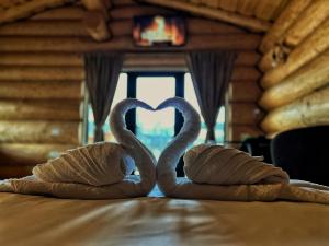 two swans are forming a heart on a table at EastWood Cabins in Moisei