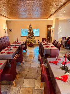 a dining room with tables and a christmas tree at Weinquartier Burggarten in Bad Neuenahr-Ahrweiler