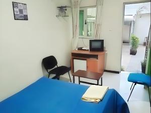 a room with a bed and a desk and a computer at Wib Guesthouse in Addis Ababa +17 photos