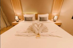 Postel nebo postele na pokoji v ubytování Carrara Hotel Hatyai