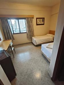 Postel nebo postele na pokoji v ubytování GRAN Parana SUITES HOTEL Asunción Centro