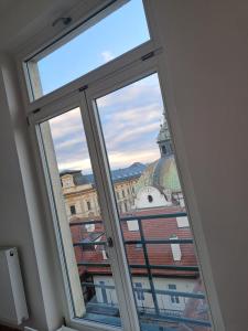 a window in a room with a view of a building at Apartman MWM Brno 2 in Brno