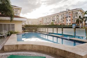 a swimming pool in front of a building at AR09 HBRentals 1BR Smart Unit in Davao City