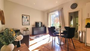 una sala de estar con una mesa y sillas en Notting Hill - The One One One -2-, en Londres
