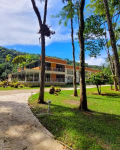 a building with trees in front of it at Pousada DOliver in Paraty