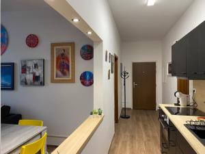 a kitchen with white walls and a wooden counter top at Art Design Gallery - Bratislava city center in Bratislava
