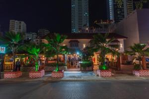 a building with palm trees in a city at night at Hotel Baluarte Cartagena Boutique in Cartagena de Indias