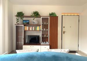 a bedroom with a bed and a book shelf at Maison Peschiera in Sirolo