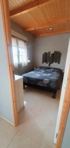 a bedroom with a bed in a room with a wooden ceiling at Casa Llogan 4P Quinta das Pedras da Lagoa in Alcobaça