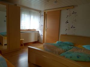 a bedroom with a bed and a large mirror at Ferienwohnung Berndt in Schwarzatal