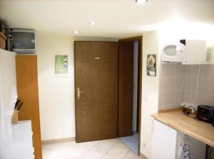a kitchen with a wooden door in a room at Ferienwohznung Huhle in Rabenau