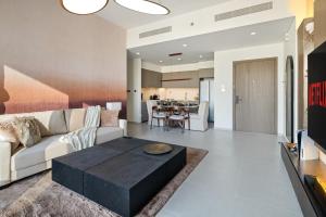 a living room with a couch and a table at Bella Elite Homes at Grande Signature Amazing Burj and Fountain View-Brand New Luxury Apartment in Dubai +108 photos