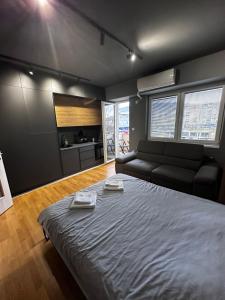 a bedroom with a large bed and a couch at Ambe Apartments in Bitola