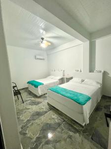 Voodi või voodid majutusasutuse Hotel Guamaluno toas