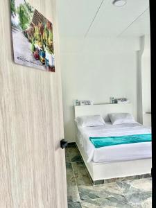 Postel nebo postele na pokoji v ubytování Hotel Guamaluno + 22 fotografií