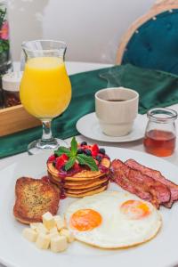 a plate of breakfast food with eggs bacon and toast at Hotel Baluarte Cartagena Boutique in Cartagena de Indias +153 photos