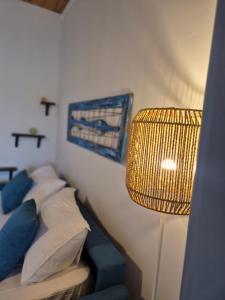 a bedroom with a bed with a lamp and a painting at Appartamento I TRE SANTI in Bisceglie