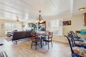 a dining room with a table and chairs at Palm Tree Escape in South Padre Island