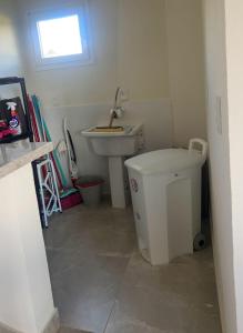 a bathroom with a sink and a toilet at Casa em condomínio rural in Rancho Queimado +41 photos