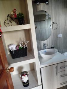 a bathroom with a sink and a mirror at Cabaña Assyria in Zapatoca